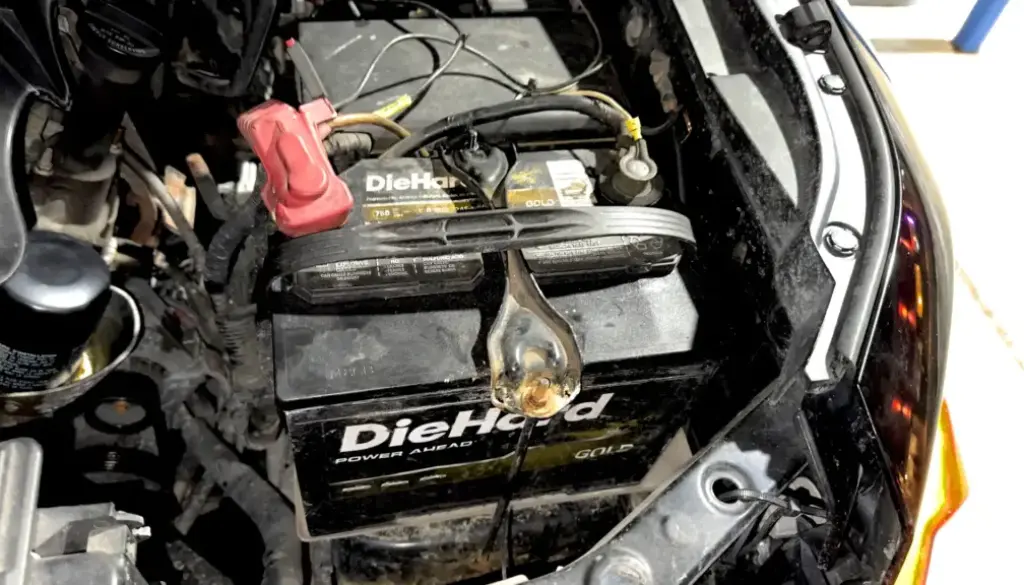 Toyota FJ Cruiser engine bay with battery hold downs re-securing the battery in its tray after shifting loose.