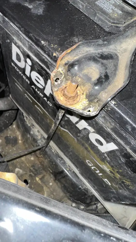 Front battery hold downs hardware, properly tightened, close up.