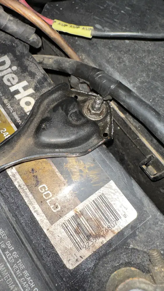 Rear battery hold downs hardware, properly tightened, close up.