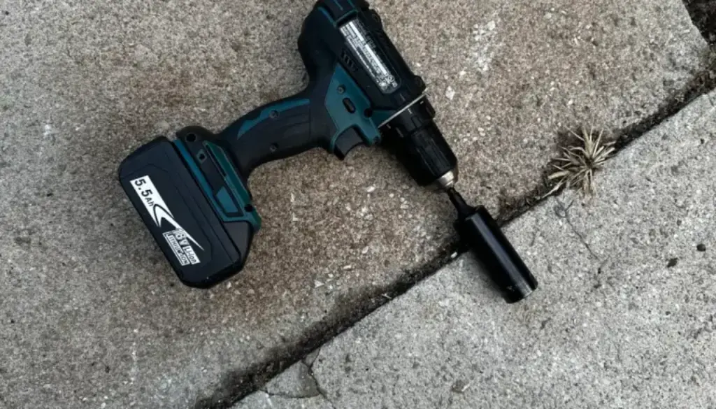 A Makita-brand drill is laying on the ground with a socket adapter and a 21mm deep impact socket is on the end. Representative of how important borrowed tools can be.